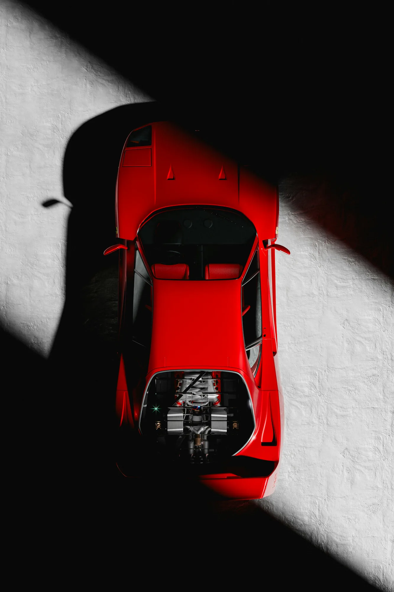Red Ferrari F40 from above, half in shadow
