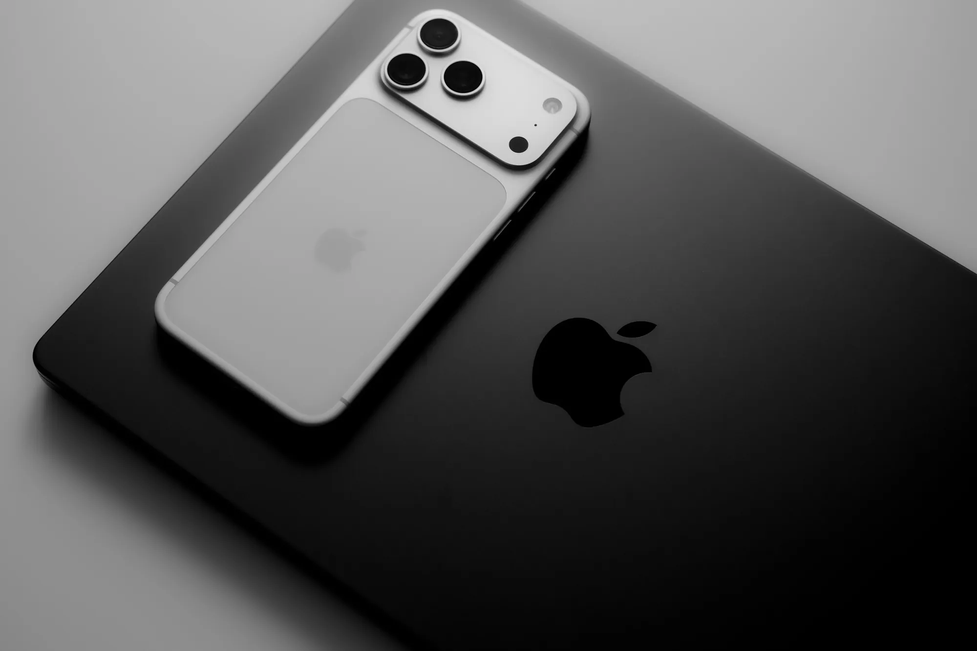 iPhone resting on a MacBook